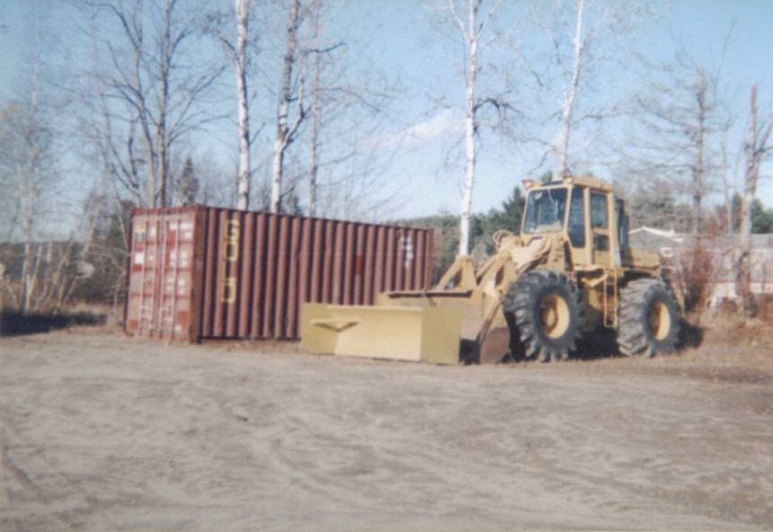 Front-end loader and a shipping container